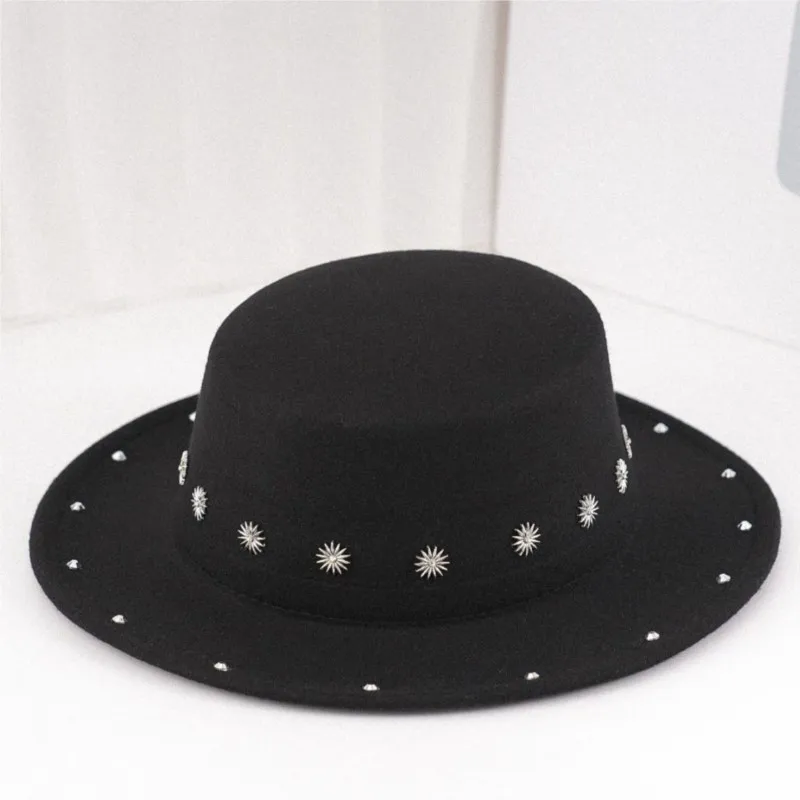 A stylish and versatile black felt flat-topped wide-brimmed top hat with star-studded rivets
A stylish and versatile black felt flat-topped wide-brimmed top hat with star-studded rivets