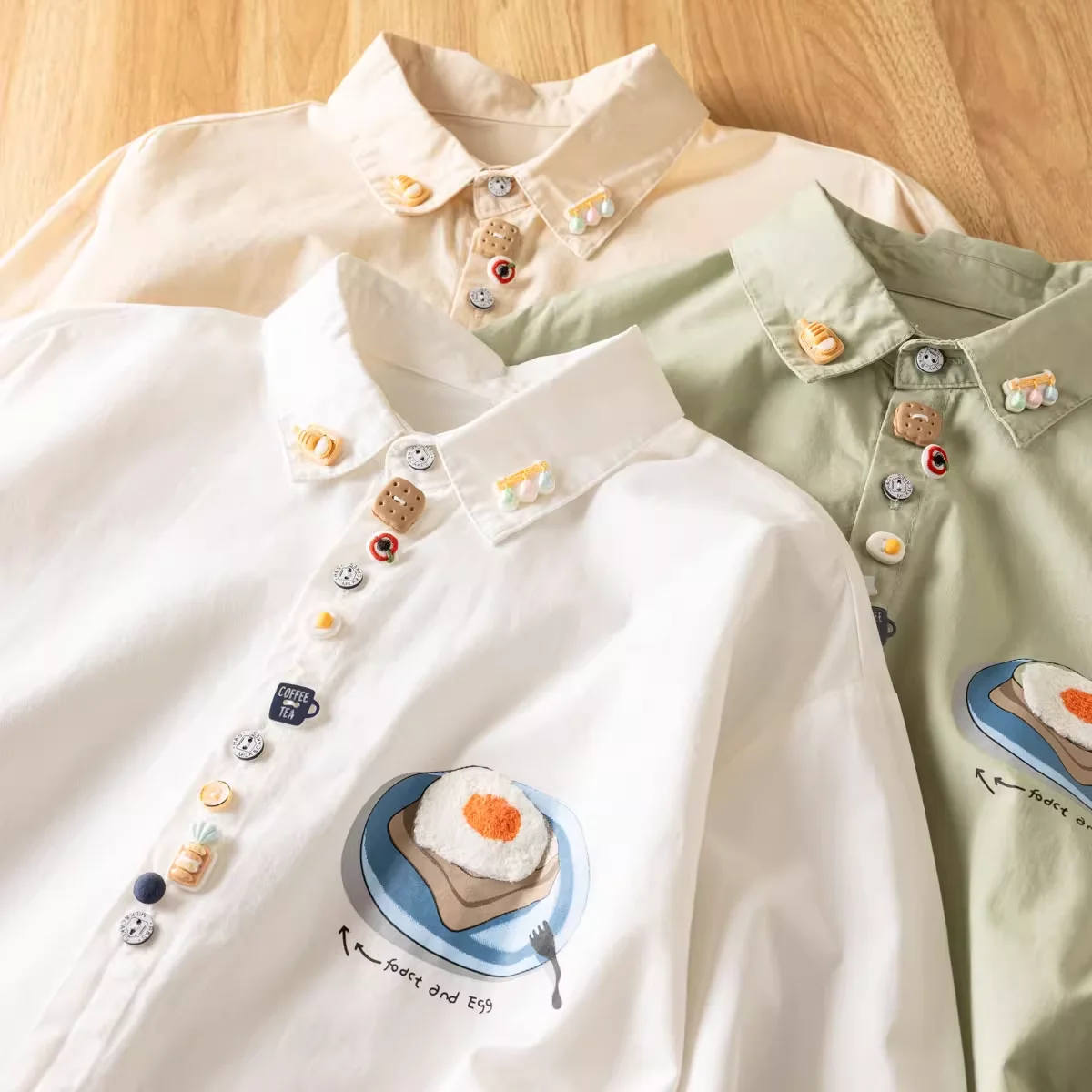 2025 Japanese vintage fashion cartoon buttons white beige green shirts and blouses for women spring long sleeve tops
2025 Japanese vintage fashion cartoon buttons white beige green shirts and blouses for women spring long sleeve tops