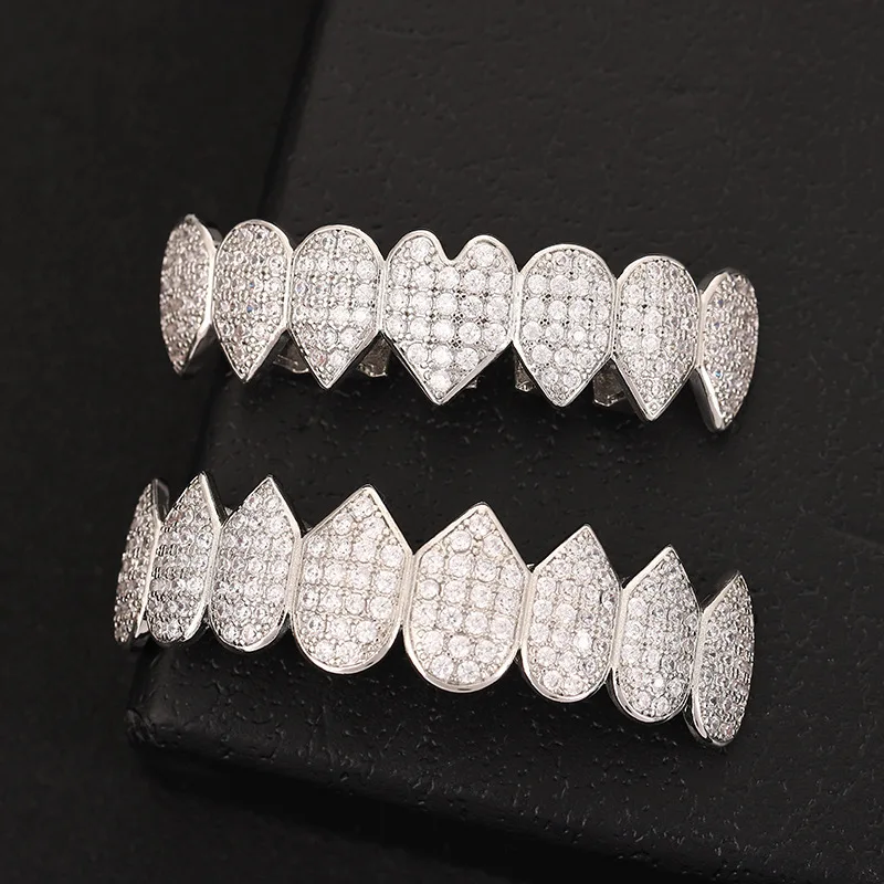 Iced out Irregular Heart Cubic Zircon Teeth Grillz Set for Men And Women Top And Bottom Brass Material Hip Hop Cosplay Decor
Iced out Irregular Heart Cubic Zircon Teeth Grillz Set for Men And Women Top And Bottom Brass Material Hip Hop Cosplay Decor