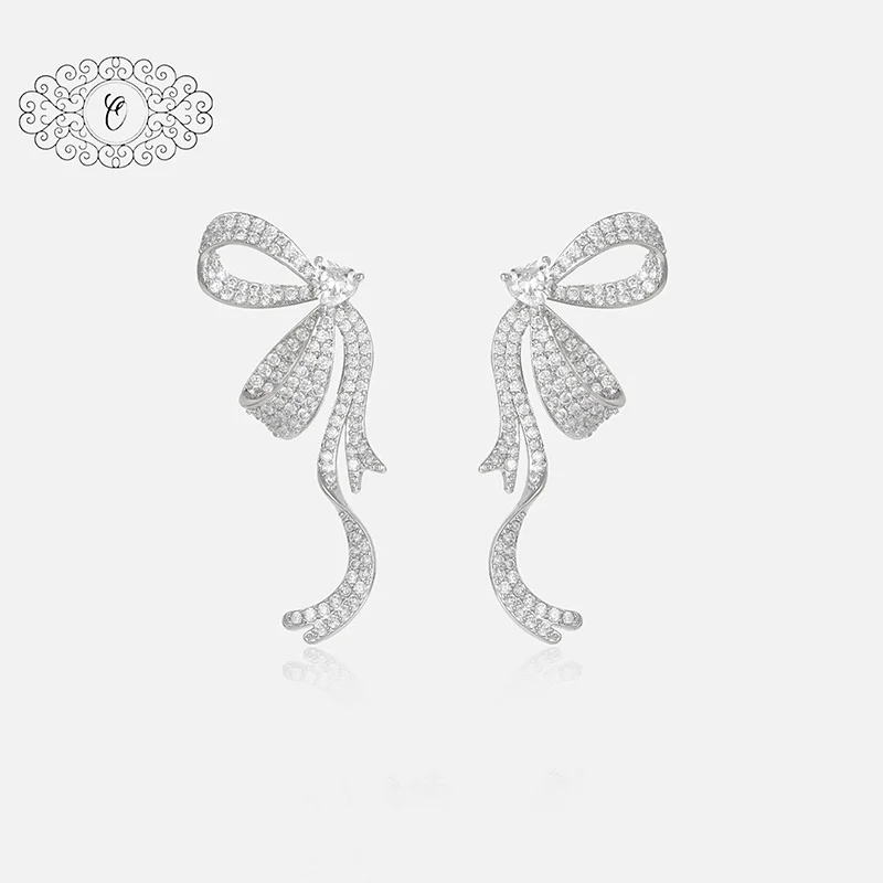 Glittering Crystal Bow Ear Studs, Perfectly Symmetrical with Dangling Sparkle, Ideal Gift for Elegant Occasions
Glittering Crystal Bow Ear Studs, Perfectly Symmetrical with Dangling Sparkle, Ideal Gift for Elegant Occasions