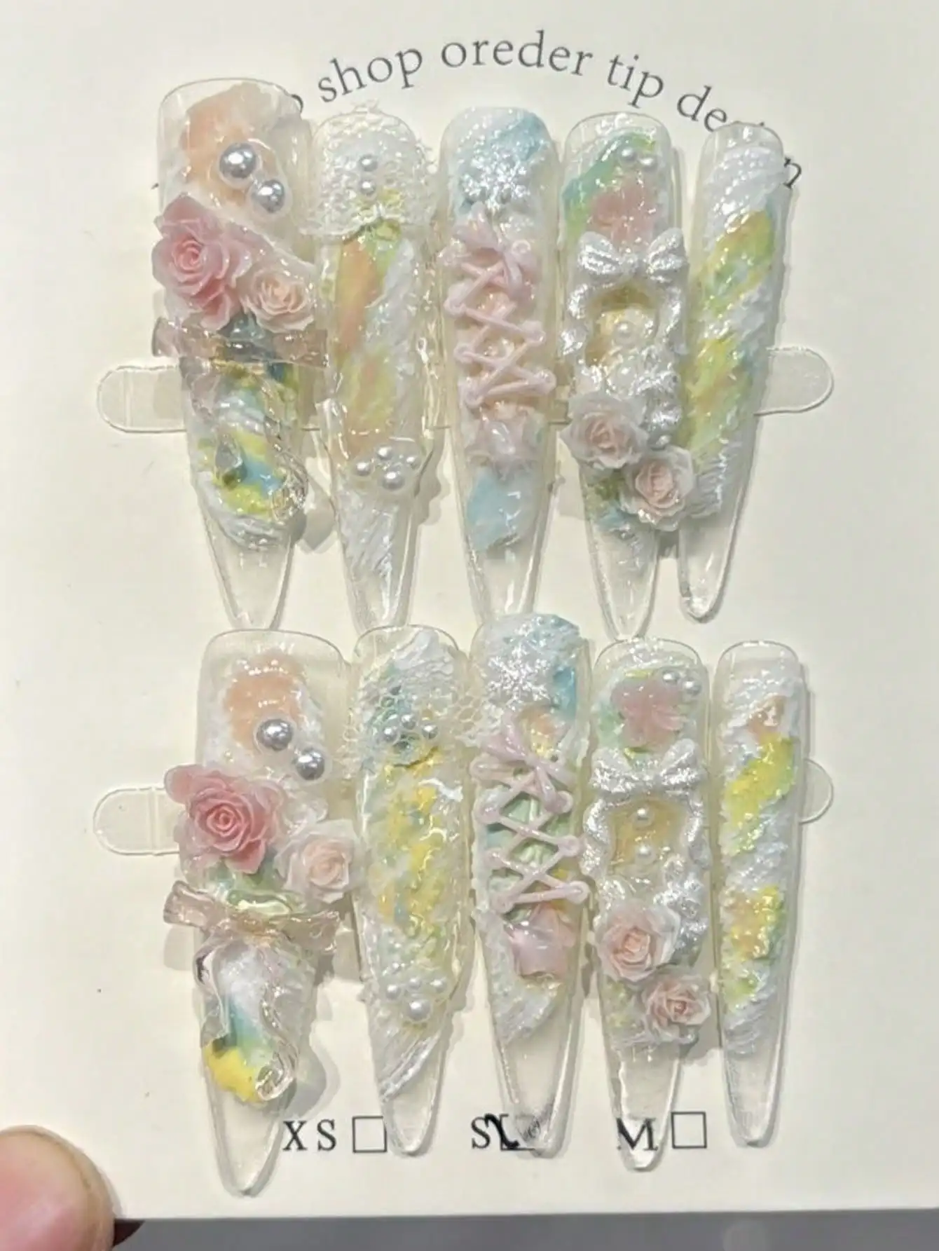 10pcs Handmade Almond-Shaped Extended False Nails, Baroque Style Painting Inspired Nail Art, Dopamine Color Scheme, Fresh And Clean. The Nails Are Based On Yellow, Pink And Blue Colors, Decorated With Pink Roses, Transparent Ribbon Bows, White Pearls And
10pcs Handmade Almond-Shaped Extended False Nails, Baroque Style Painting Inspired Nail Art, Dopamine Color Scheme, Fresh And Clean. The Nails Are Based On Yellow, Pink And Blue Colors, Decorated With Pink Roses, Transparent Ribbon Bows, White Pearls And