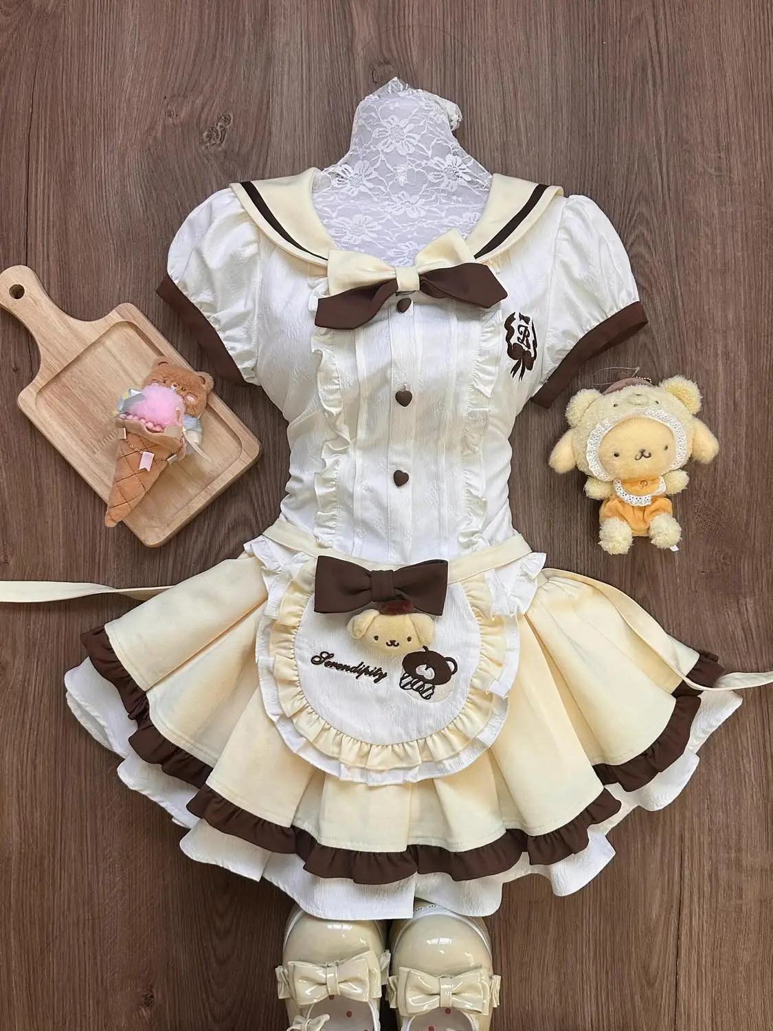 Комплект из трех предметов: блузка с матросским воротником, плиссированная юбка с узлом и фартук-футляр, с коротким рукавом, на пуговицах, из полиэстера
Комплект из трех предметов: блузка с матросским воротником, плиссированная юбка с узлом и фартук-футляр, с коротким рукавом, на пуговицах, из полиэстера