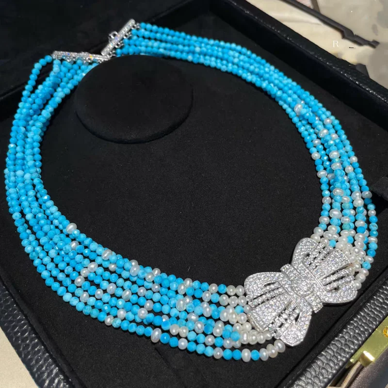 ZOCA Rows Synthetic Blue Turquoise Faceted Round Stone Beaded Chokers 925 silver bowknot Pendant Necklace Multi Strand Necklace
ZOCA Rows Synthetic Blue Turquoise Faceted Round Stone Beaded Chokers 925 silver bowknot Pendant Necklace Multi Strand Necklace