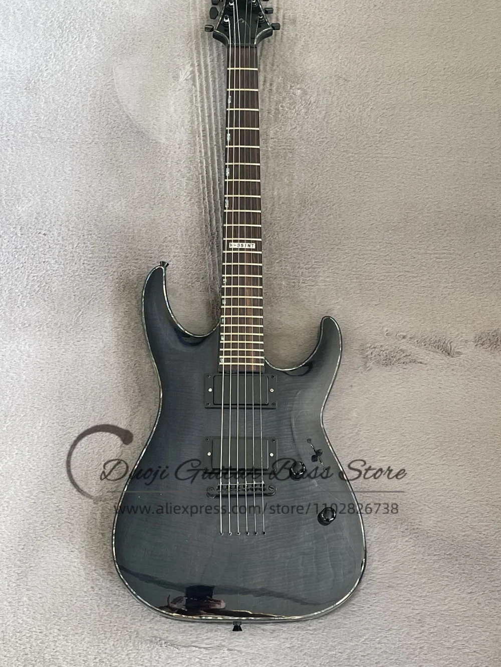 Transparent black guitar, fixed bridge, flamed maple top, maple neck set in solid wood body, abalone binding, HH pickups
Transparent black guitar, fixed bridge, flamed maple top, maple neck set in solid wood body, abalone binding, HH pickups