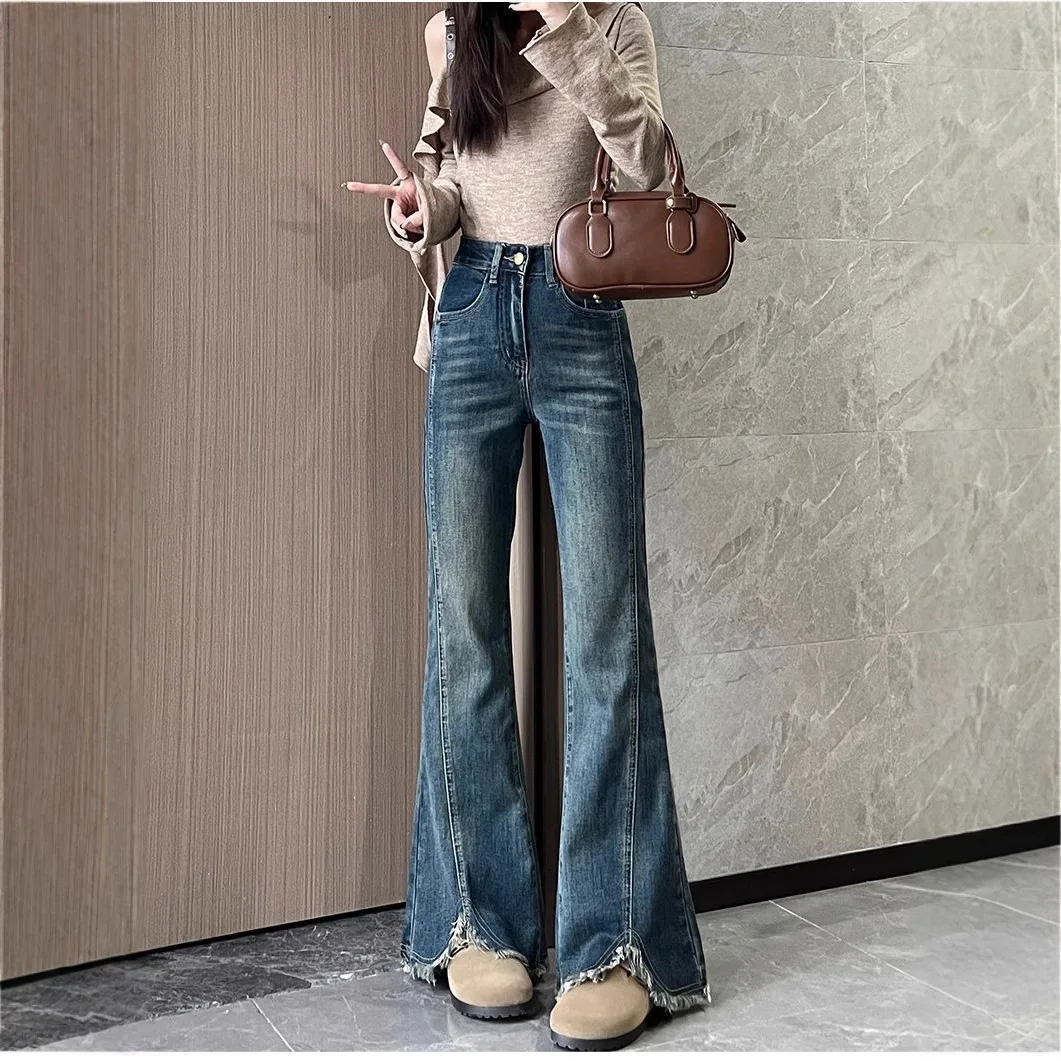 Women's stylish denim jeans, stretchy blue-gray with frayed edges, slit, high-waisted, leg-lengthening, flared
Women's stylish denim jeans, stretchy blue-gray with frayed edges, slit, high-waisted, leg-lengthening, flared