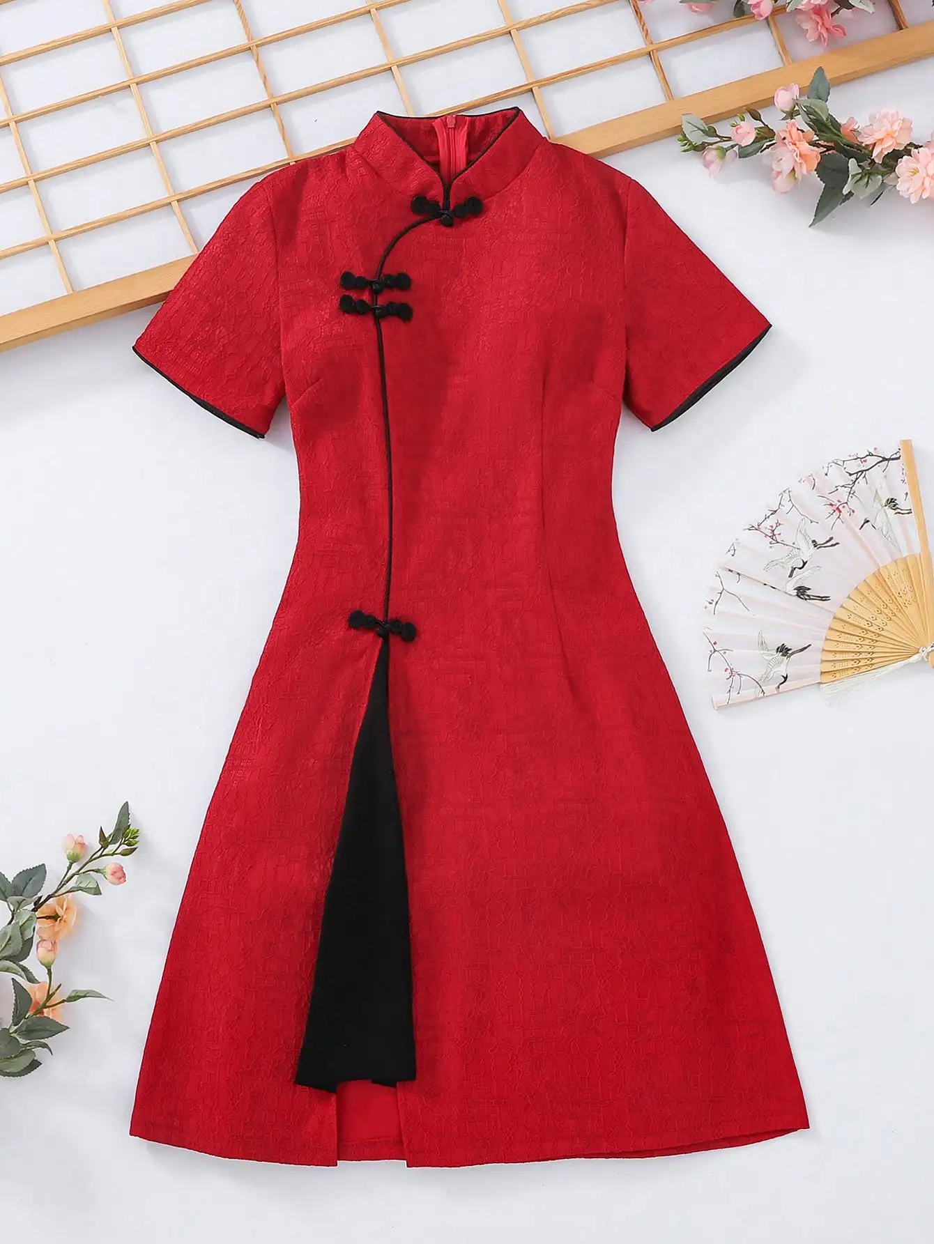 Red Modified Cheongsam-Style Dress with Black Trim and Frog Buttons
Red Modified Cheongsam-Style Dress with Black Trim and Frog Buttons