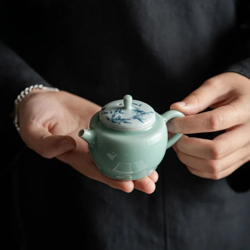Чайник из селадоновой керамики ручной росписи, 100 мл, с бамбуковой ручкой, керамический, с фильтром, китайский фарфоровый чайник для заваривания чая, инструмент для чайной церемонии Кунг-фу, подарок
Чайник из селадоновой керамики ручной росписи, 100 мл, с бамбуковой ручкой, керамический, с фильтром, китайский фарфоровый чайник для заваривания чая, инструмент для чайной церемонии Кунг-фу, подарок