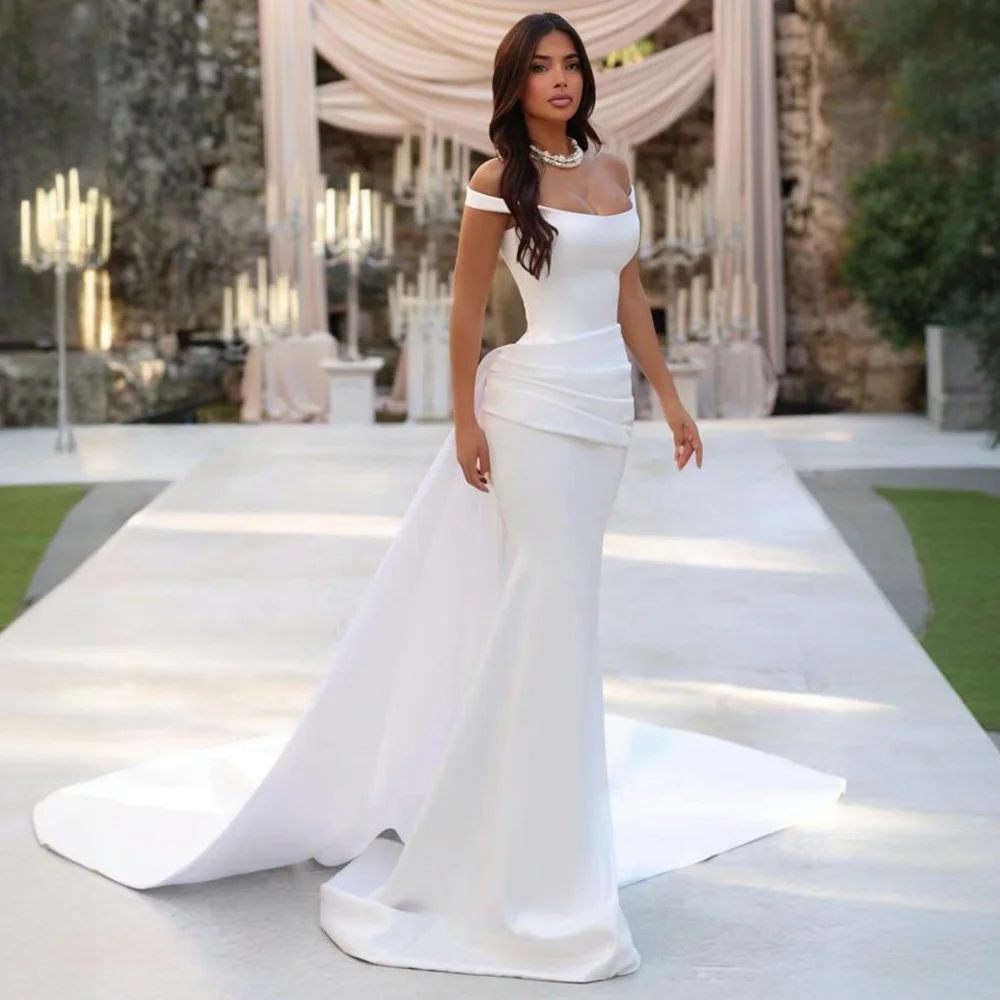 Свадебное платье на заказ в современном стиле, с открытыми плечами, фасон «русалка», цвета слоновой кости, со съемным шлейфом, из атласа, элегантное.
Свадебное платье на заказ в современном стиле, с открытыми плечами, фасон «русалка», цвета слоновой кости, со съемным шлейфом, из атласа, элегантное.