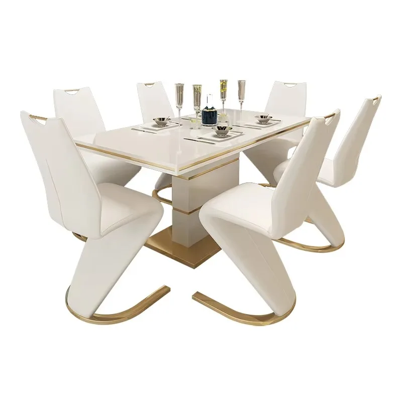 Gold and white luxury dining table with 6 chairs and a modern dining table set
Gold and white luxury dining table with 6 chairs and a modern dining table set