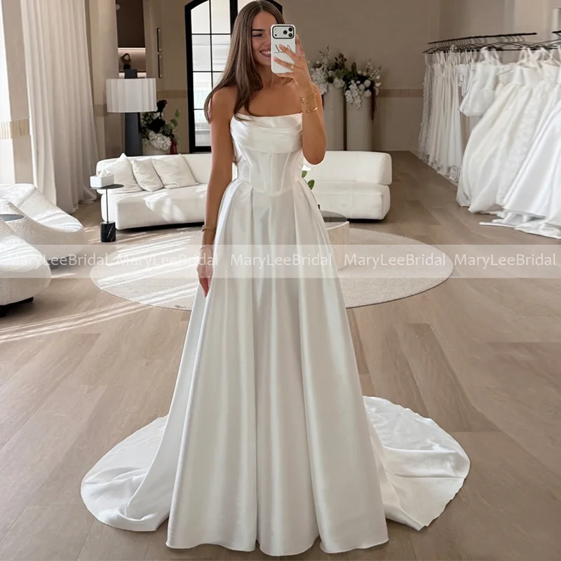 2026 Strapless Satin Wedding Dress for Bride Corset Bodice A-line Minimalist Bridal Gown for Outdoor Ceremony Wedding Customized
2026 Strapless Satin Wedding Dress for Bride Corset Bodice A-line Minimalist Bridal Gown for Outdoor Ceremony Wedding Customized