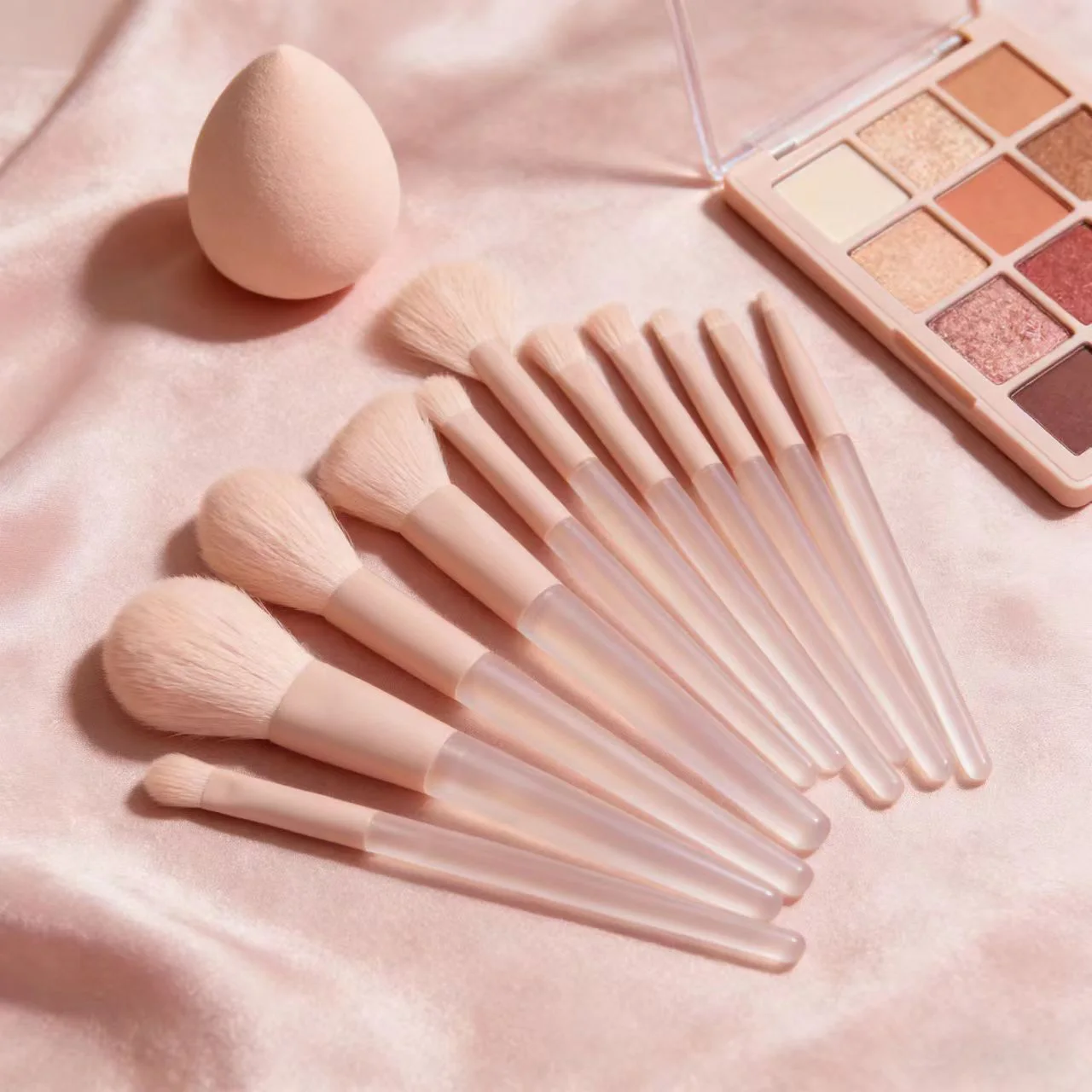 A 12-piece set of pink makeup brushes including powder, foundation, contouring, and eyeshadow tools for makeup application.
A 12-piece set of pink makeup brushes including powder, foundation, contouring, and eyeshadow tools for makeup application.