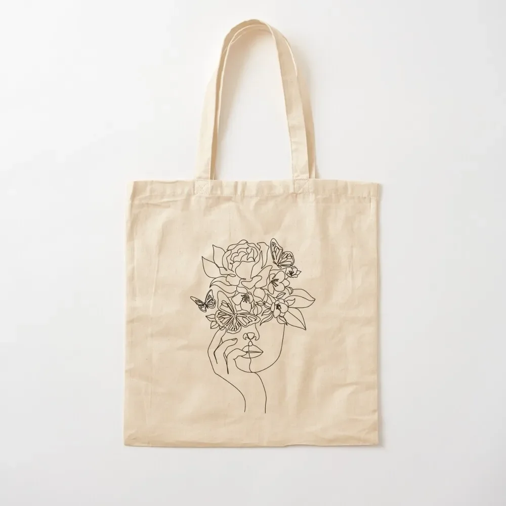 Flower in woman head. Vector line illustration. Line drawing. One line. Nature face. Nature cosmetics. Flower icon. Min Tote Bag
Flower in woman head. Vector line illustration. Line drawing. One line. Nature face. Nature cosmetics. Flower icon. Min Tote Bag