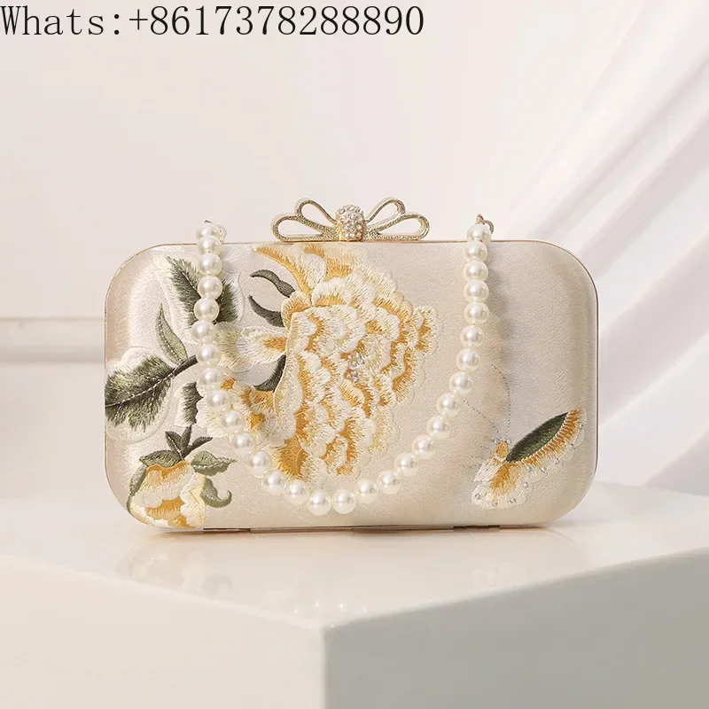 Embroidered Chinese style cheongsam with bag, evening dress, butterfly flower and flag in hand.
Embroidered Chinese style cheongsam with bag, evening dress, butterfly flower and flag in hand.