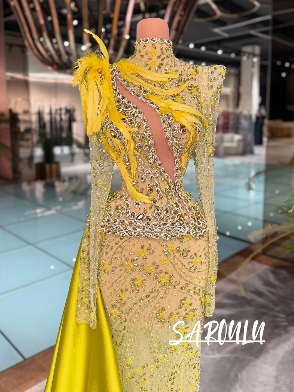Richly Yellow High Neck Long Sleeve Mermaid Evening Dress With Feather, Crystal Beading, Side Cutout & Detachable Satin Train
Richly Yellow High Neck Long Sleeve Mermaid Evening Dress With Feather, Crystal Beading, Side Cutout & Detachable Satin Train