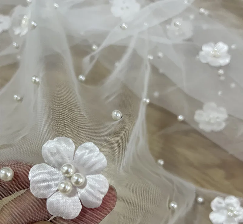 Transparent mesh embroidered fabric with pearl flowers is a perfect decoration for wedding dresses and scene arrangements
Transparent mesh embroidered fabric with pearl flowers is a perfect decoration for wedding dresses and scene arrangements