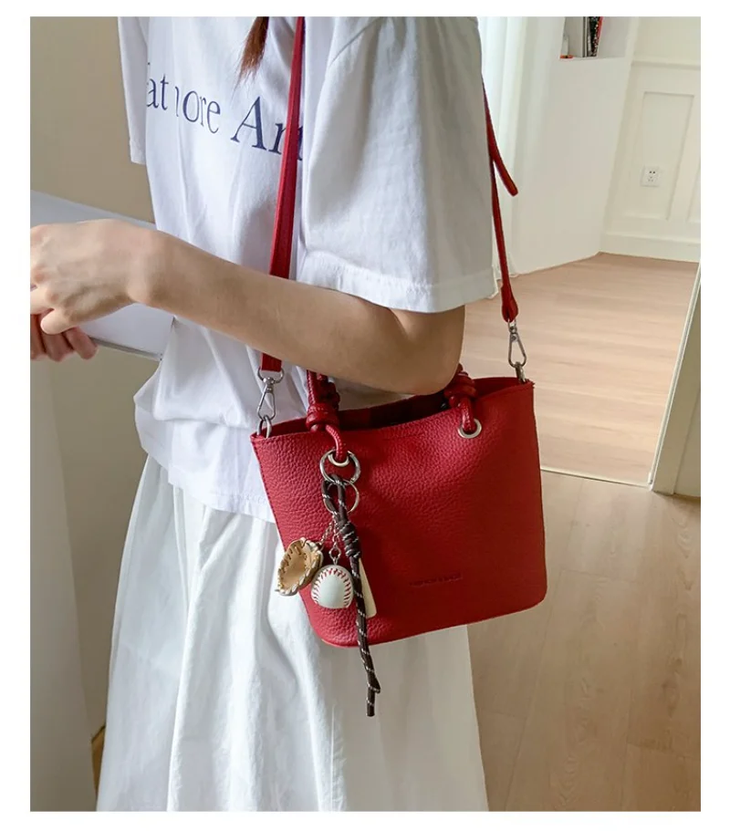 Red Textured Leather Mini Bucket Bag with Baseball Charm, Women's Casual Crossbody Purse with Top Handle for Everyday Use
Red Textured Leather Mini Bucket Bag with Baseball Charm, Women's Casual Crossbody Purse with Top Handle for Everyday Use
