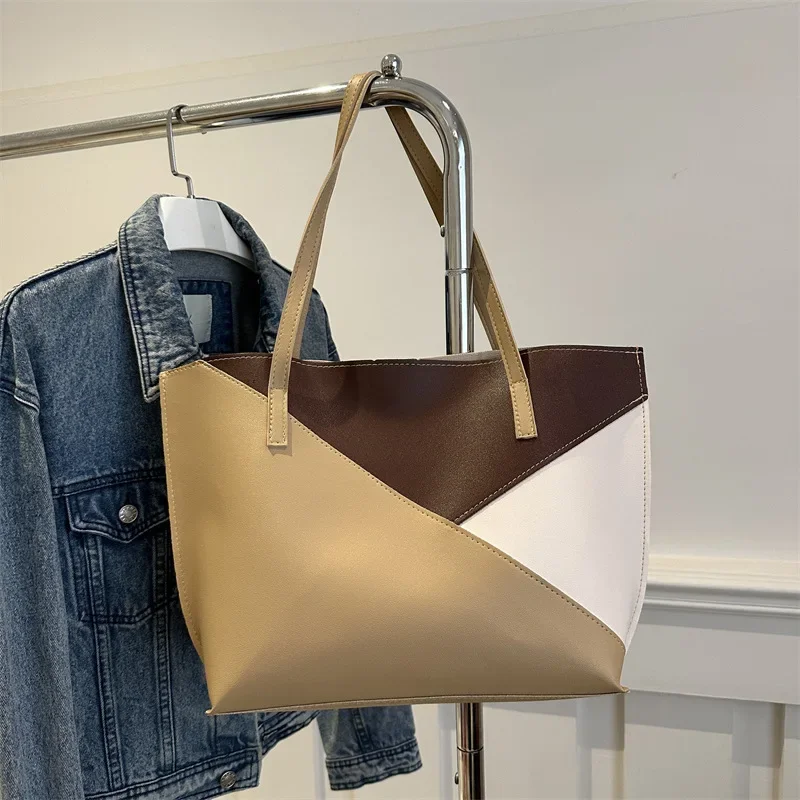 Simple tote bag, large-capacity shoulder bag, commuter bag, splicing, contrasting color and texture women's bag.
Simple tote bag, large-capacity shoulder bag, commuter bag, splicing, contrasting color and texture women's bag.
