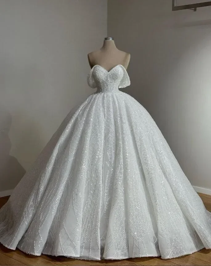 Customized Luxury Off The Shoulder Sparkly Princess Wedding Dresses Pearls Beaded Skirt Garden Bridal Gown Vestido De Novia
Customized Luxury Off The Shoulder Sparkly Princess Wedding Dresses Pearls Beaded Skirt Garden Bridal Gown Vestido De Novia