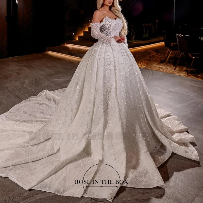 ROSEINTHEBOX Stunning Off The Shoulder Beaded Pearls Wedding Dress Long Sleeve A-line with Long Train Customized for Brides
ROSEINTHEBOX Stunning Off The Shoulder Beaded Pearls Wedding Dress Long Sleeve A-line with Long Train Customized for Brides