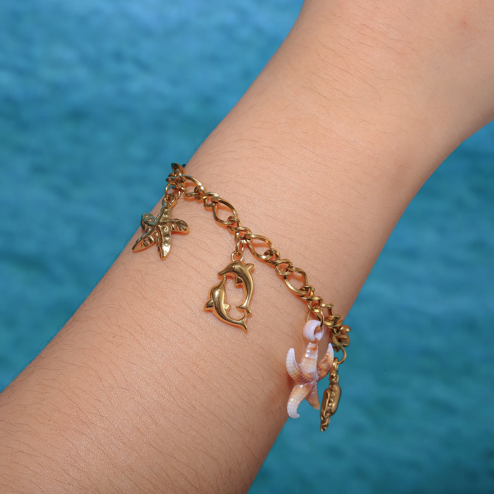 Golden Tone Stainless Steel Ocean Charm Bracelet with Dolphin Crab and Shell Pendants for Women
Golden Tone Stainless Steel Ocean Charm Bracelet with Dolphin Crab and Shell Pendants for Women