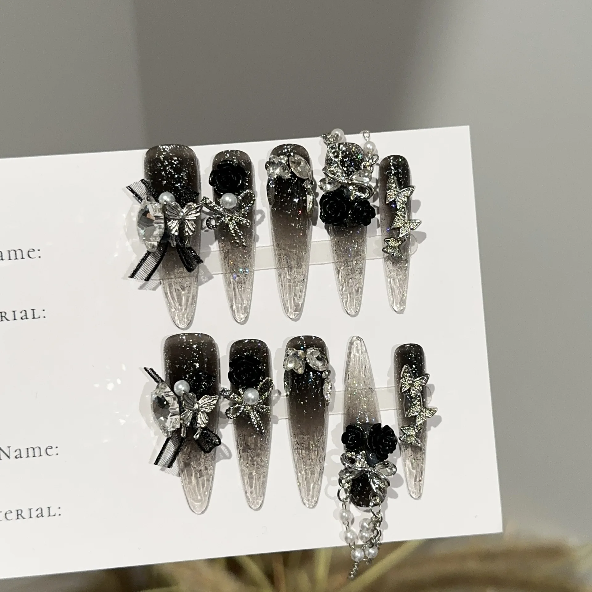 10 Pcs Long Stiletto Press on Nails Black Clear Gradient Gothic Fake Nails with Butterfly Rose Pearl Chain Charms Manicure
10 Pcs Long Stiletto Press on Nails Black Clear Gradient Gothic Fake Nails with Butterfly Rose Pearl Chain Charms Manicure