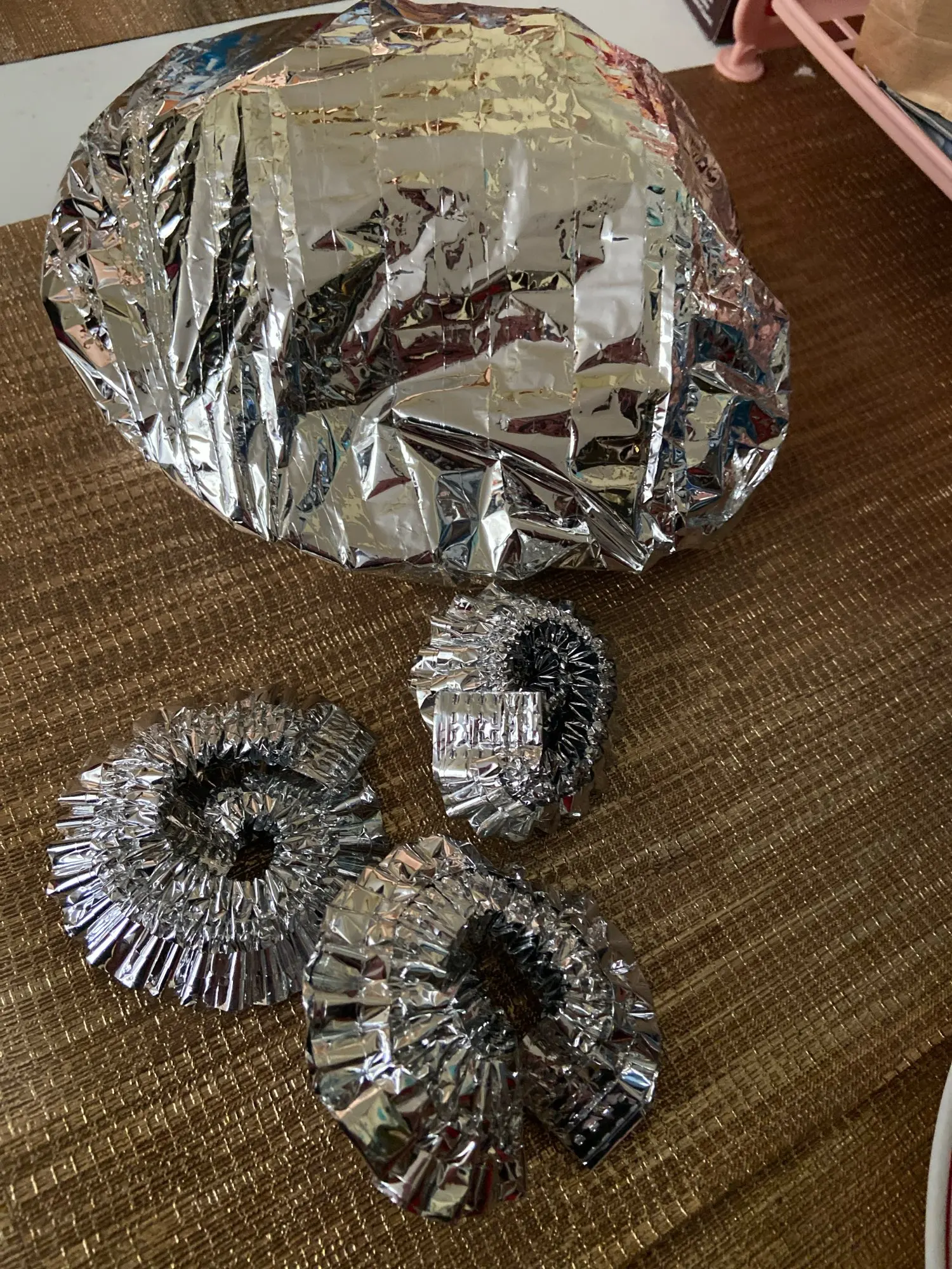 Reusable aluminum foil food cover stretched over a plate