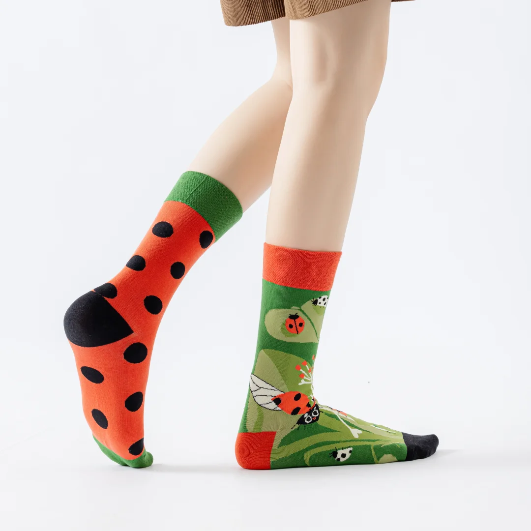 1 pair of fashionable socks with a ladybug and polka-dot print, featuring an asymmetrical design; suitable for both men and women.