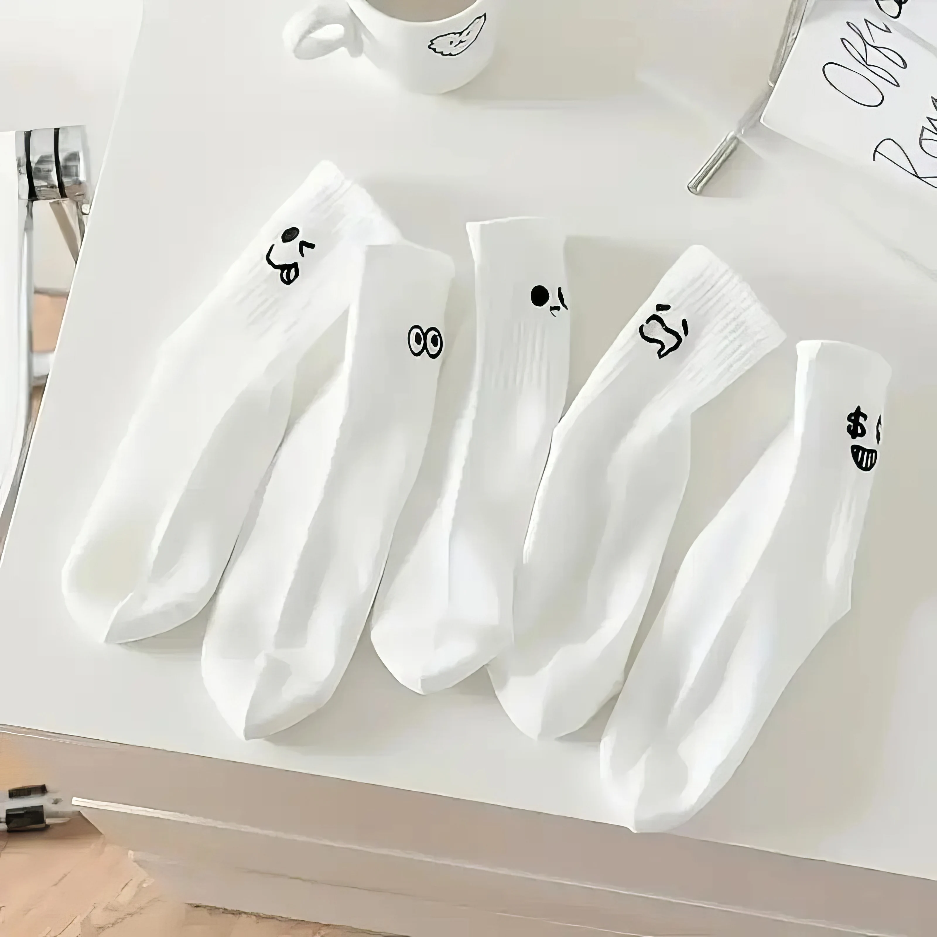 

5pairs white socks with cute cartoon faces, crafted from a breathable cotton blend for ultimate comfort and soft wear