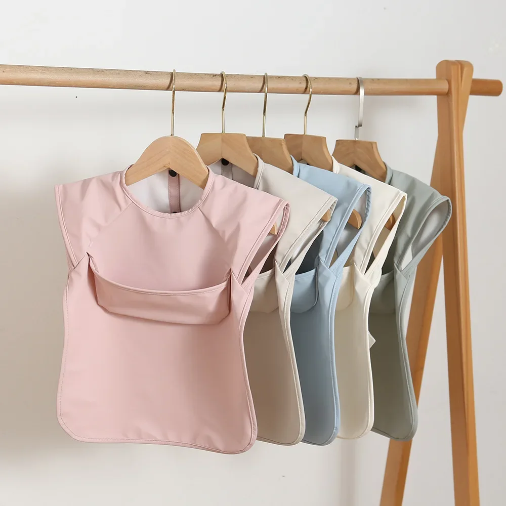 Bavoirs pour bébé, couleur unie, Smock artistique imperméable pour enfants, garçons et filles, tablier d'alimentation sans manches avec poche, articles pour bébé