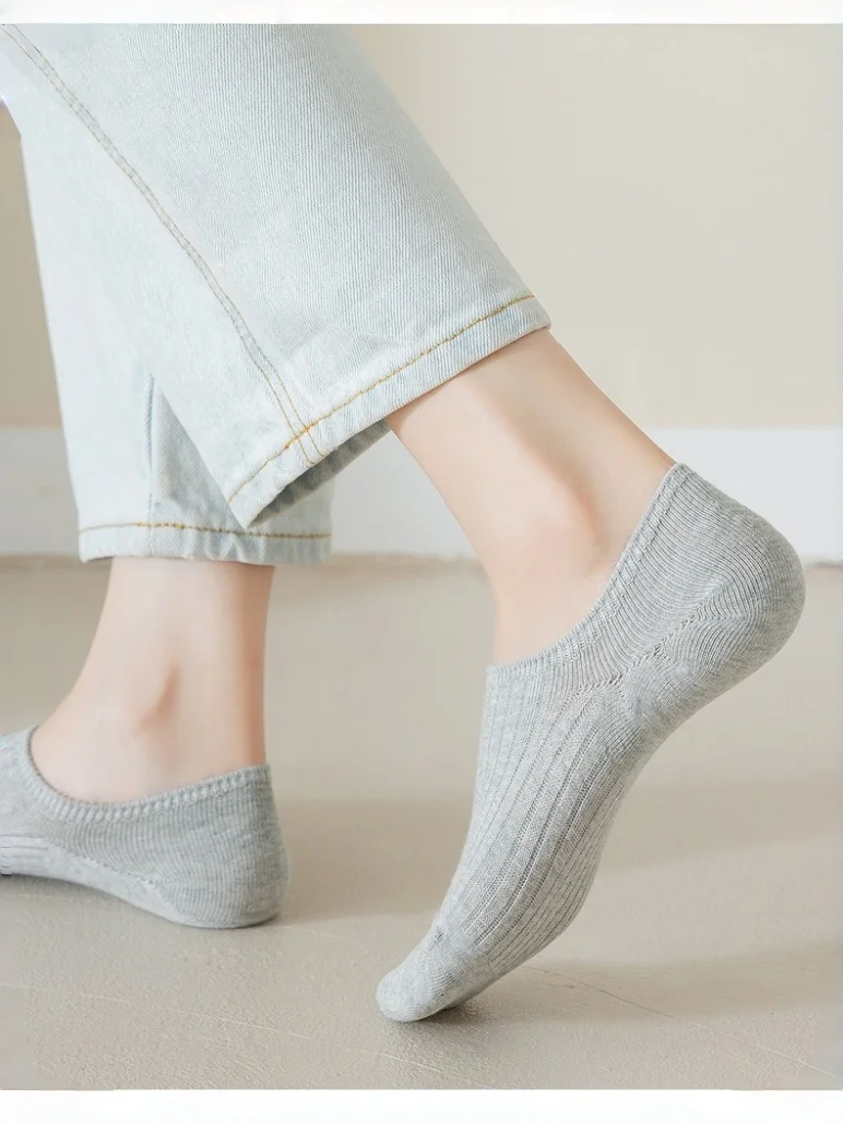 

A collection of premium cotton socks in versatile black and gray tones, ranging from deep charcoal to light heather.