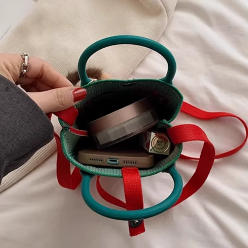 A spacious knitted small mobile wallet with a crossbody strap, suitable for women traveling with small items