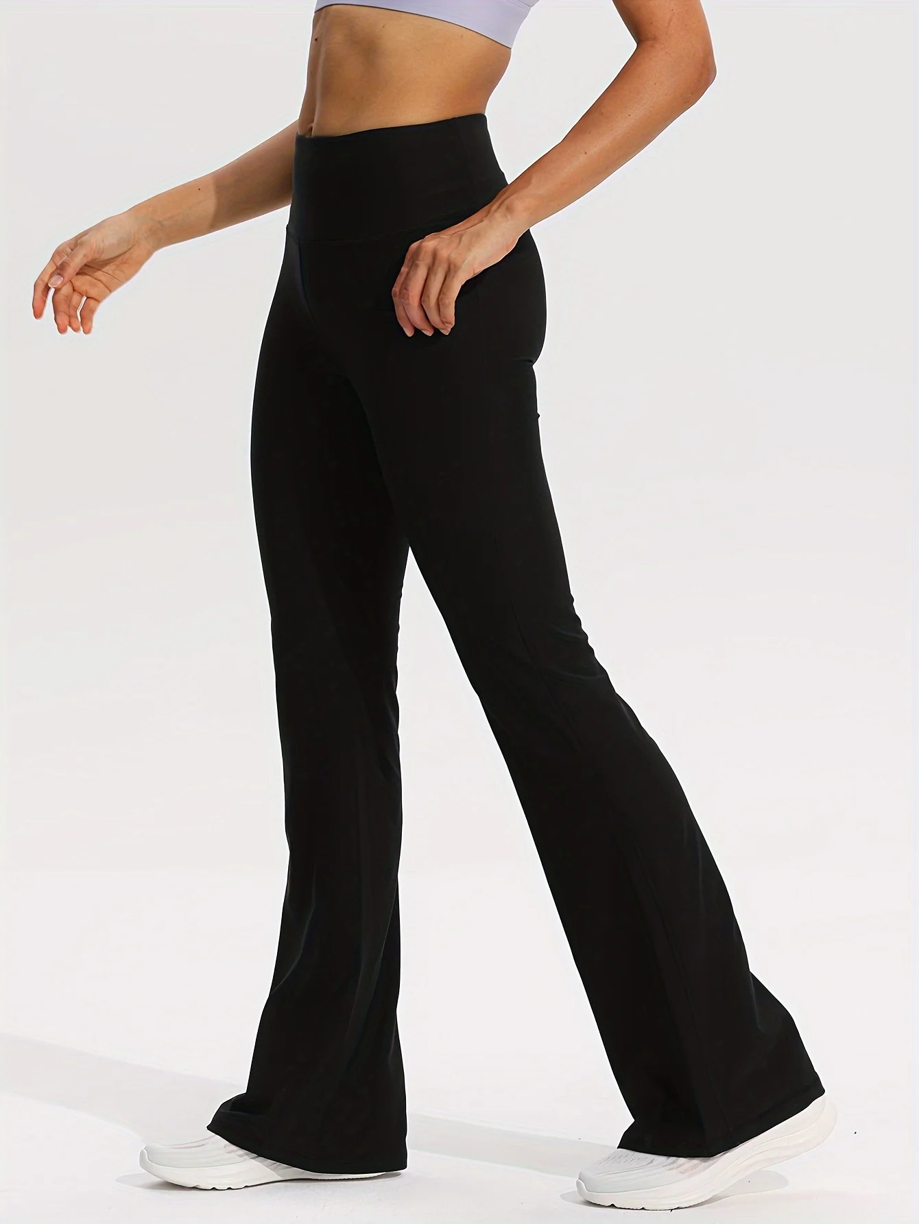 กางเกงโยคะสตรีเอวสูงสีดำ - ดีไซน์ทรงบานและมีกระเป๋า - เหมาะสำหรับเล่นกีฬาแบบสบาย ๆ ยืดได้