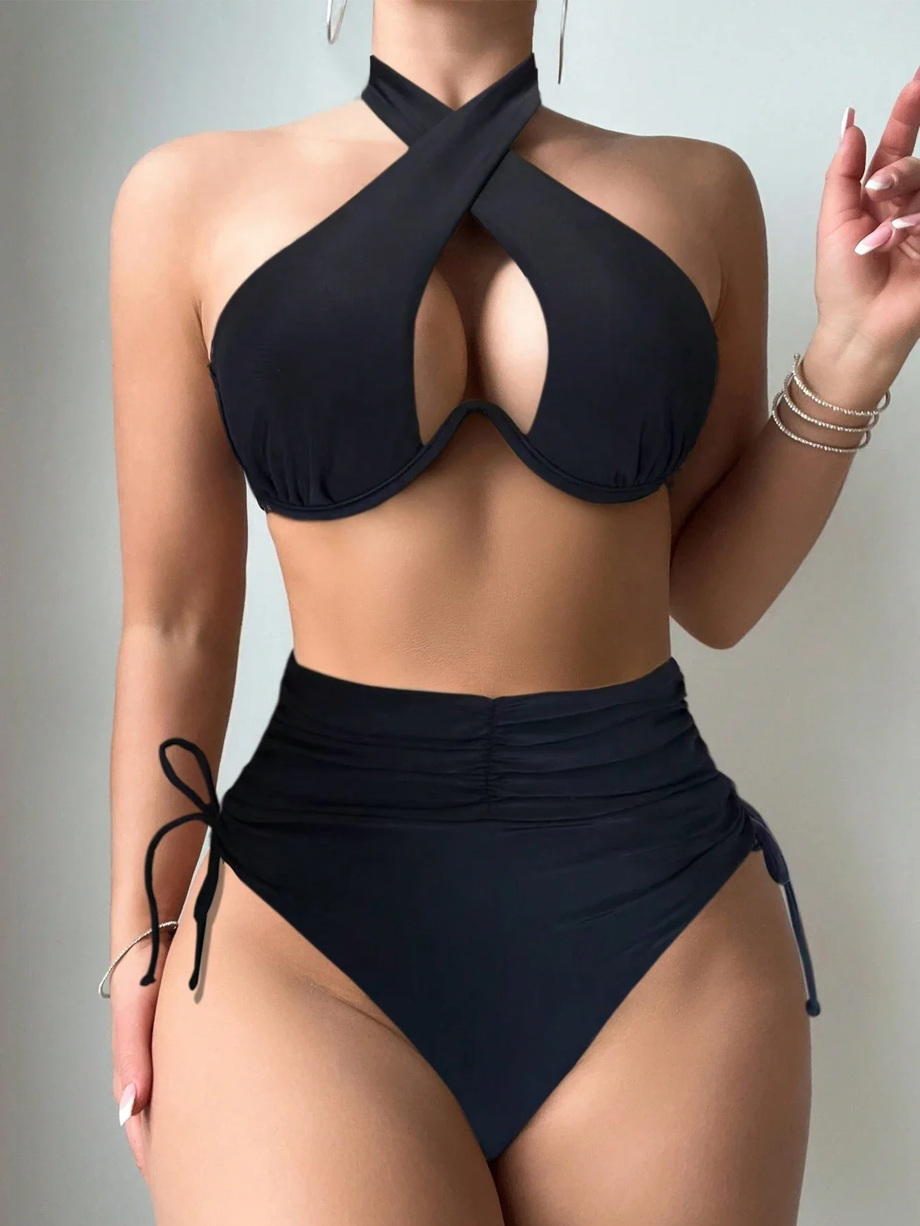 

Black crisscross halter bikini with high-waisted tie bottoms, sexy and stylish. Show off your curves and enjoy beach time