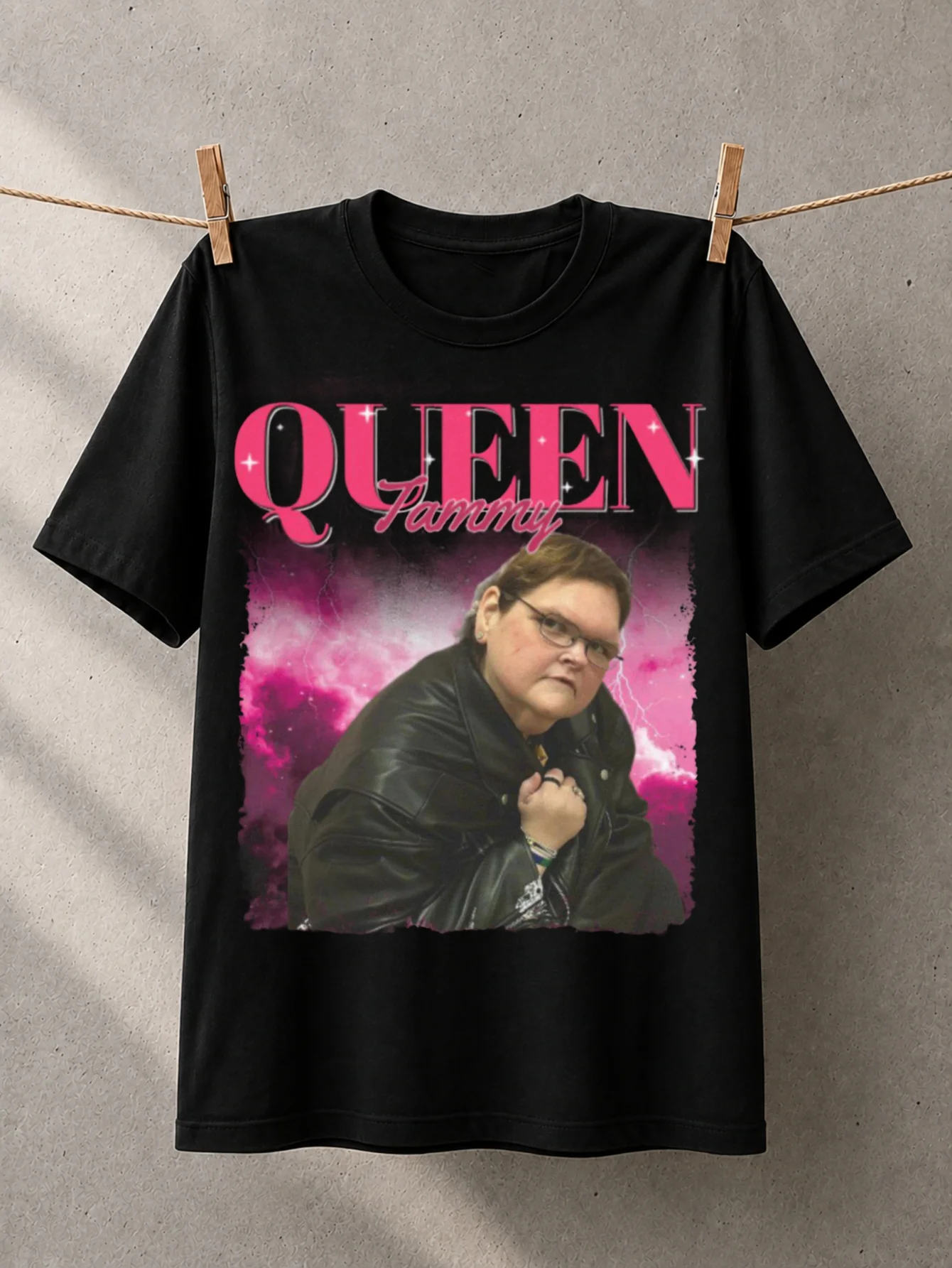 Queen Tammy Portrait Graphic T-Shirt Pink Sparkle Name Lettering with Seated Woman Image And Dramatic Magenta Cloud Background Unisex All T-Shirt