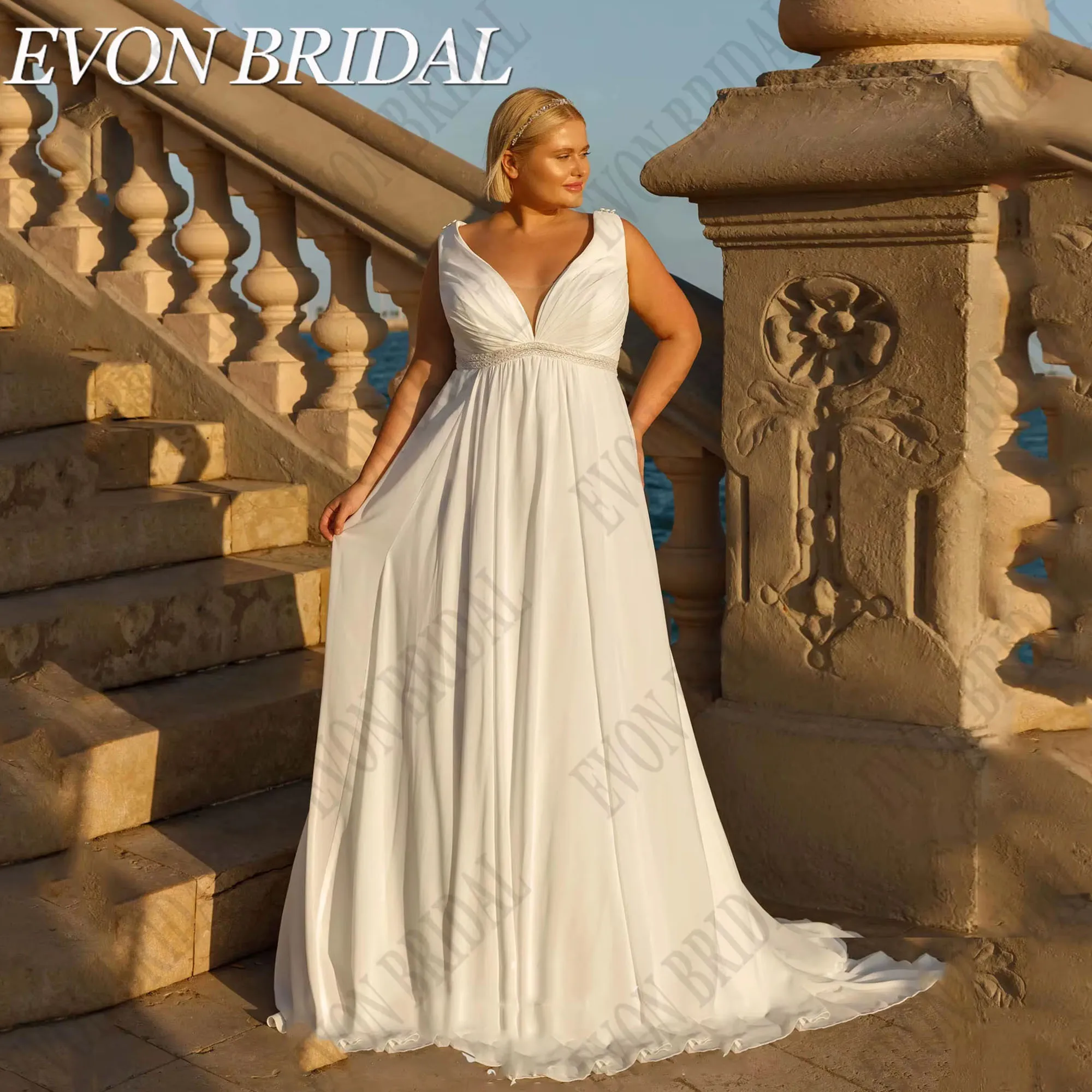 ชุดแต่งงานโอเวอร์ไซส์พร้อมผ้าคลุมไหล่ คอวี แขนกุด ชุดเจ้าสาวชายหาด ผ้าชีฟองทรงเอไลน์ ยี่ห้อ EVON BRIDAL รับตัดตามสั่ง