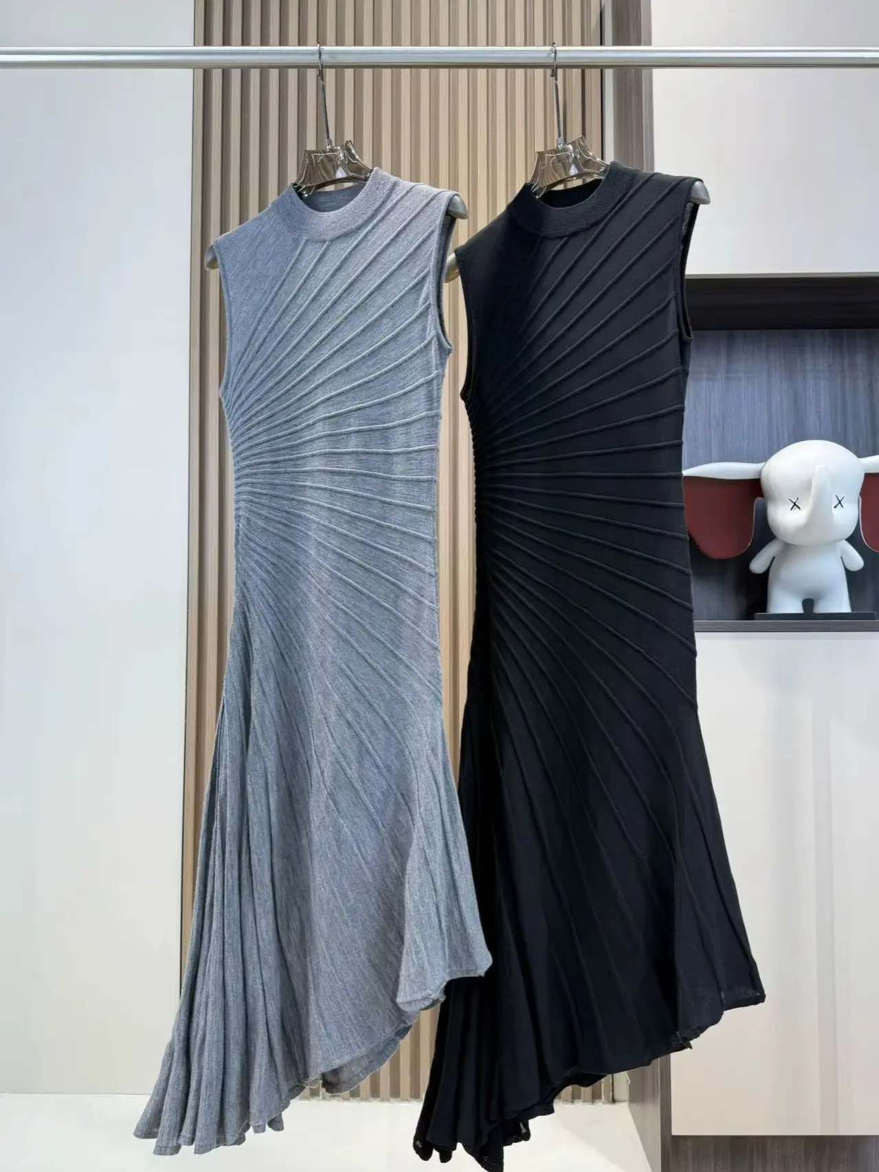 Elegant asymmetrical knitted wool dress with a slanting radiant folding design