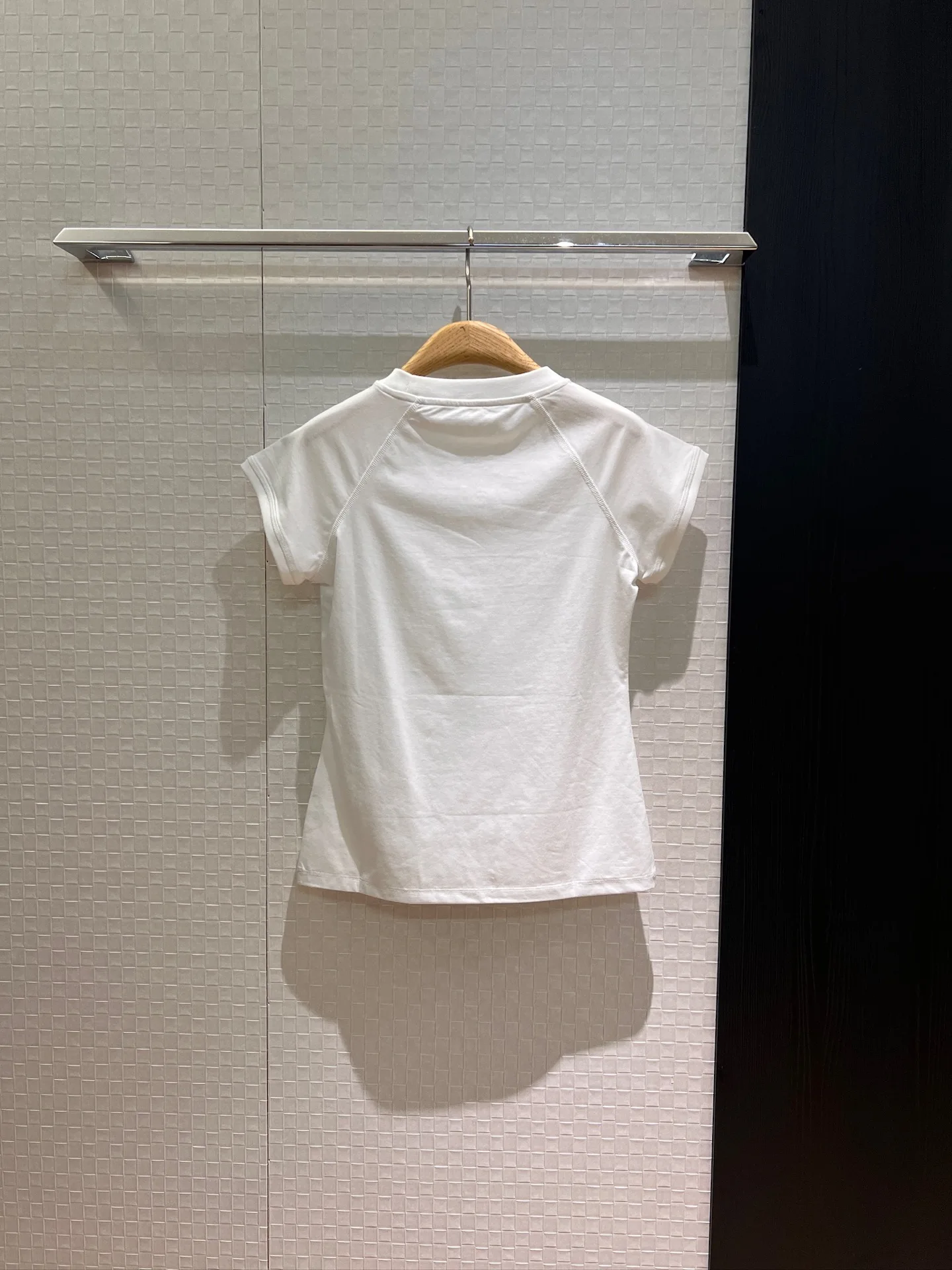 

A Small T-shirt With Classic Embroidered Badges On The Lady's Chest And Shoulder Sleeves