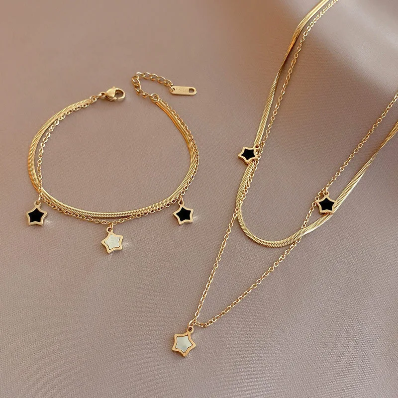 

Gold Star Charm Necklace and Bracelet Set for Women – Layered Chain Jewelry with Black & White Enamel Pendants