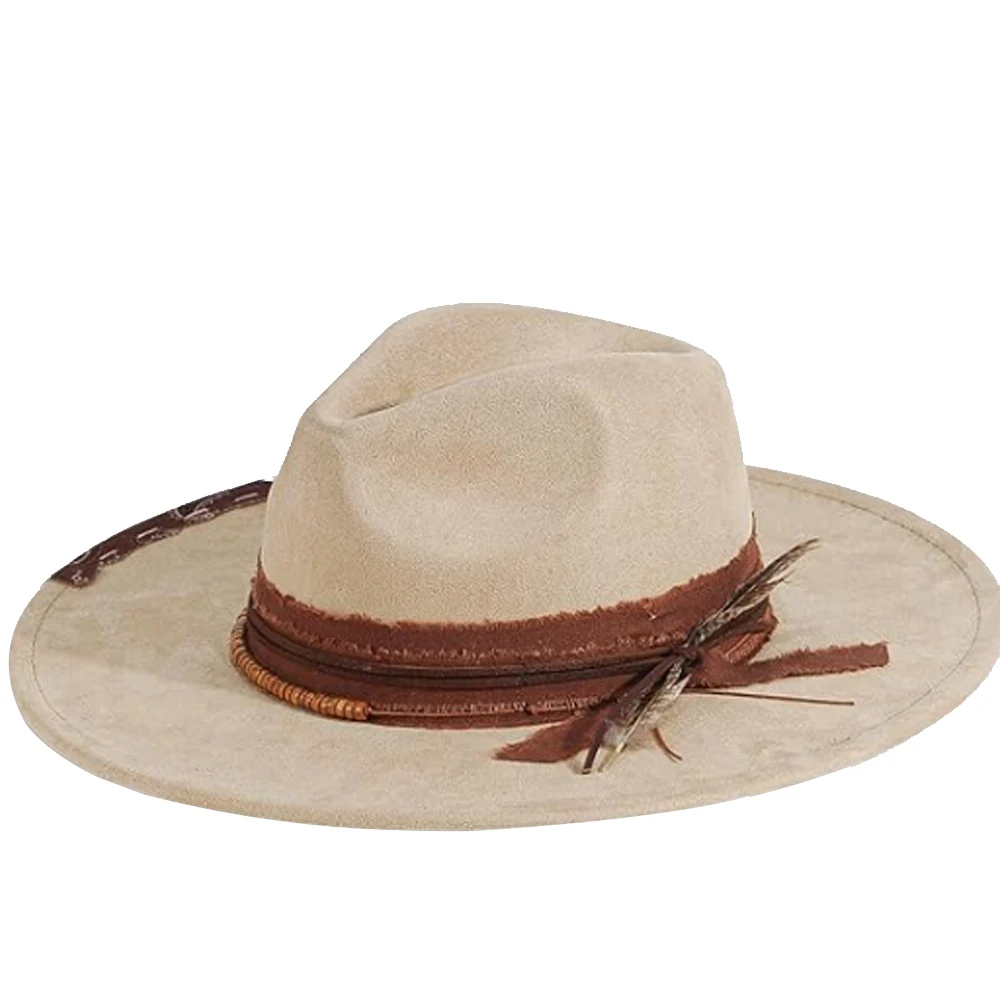 

New Western suede hat with a wide brim distressed patchwork feather and rivet embellishments and a bohemian vintage feel apelusz