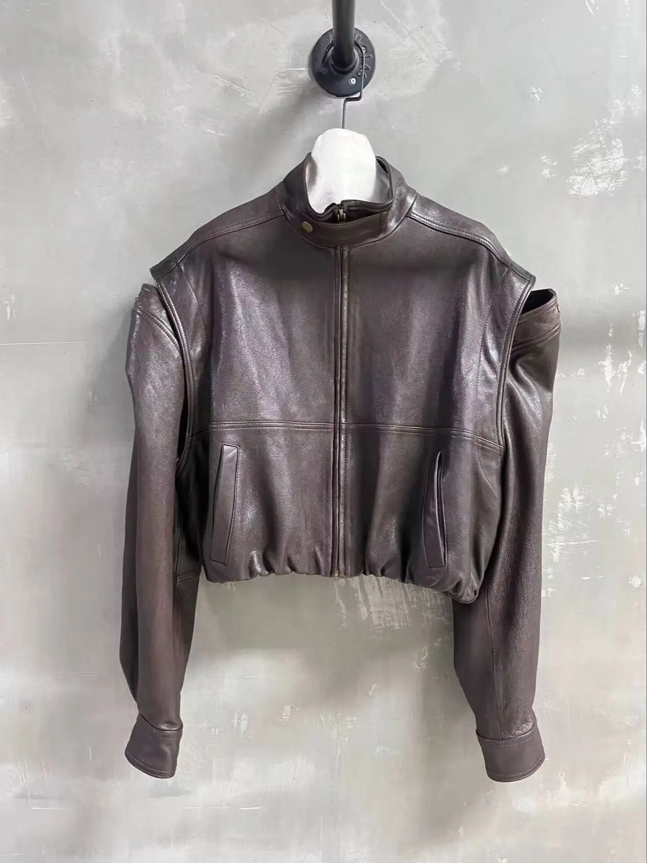 Versatile fashionable leather jacket with removable sleeves design