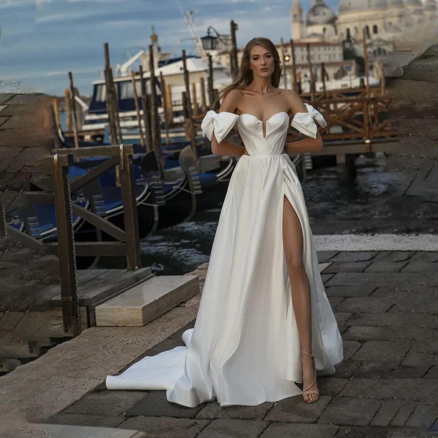

Shiny Satin Wedding Dress Features High-Split Design And V-neckline Glistening Bridal Gown with Off-the-Shoulder Bow-Tie Straps