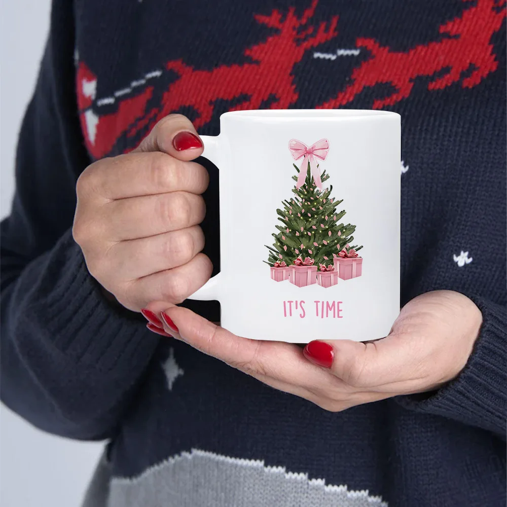 This 11-Ounce Mug Features a Watercolor Christmas Tree Print, Pink Bow, and the Phrase 