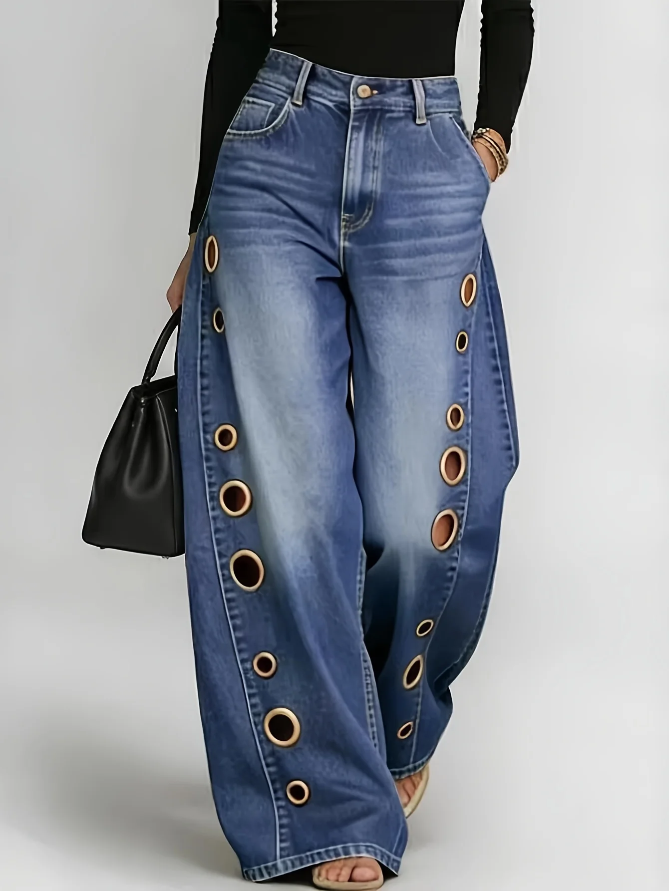 

Retro-style wide-leg jeans with metallic eyelets, high-waisted, loose, floor-length fit, gradient eyelets of varying sizes on both sides, distressed washed finish, classic front and back pockets, perfect for everyday casual wear.