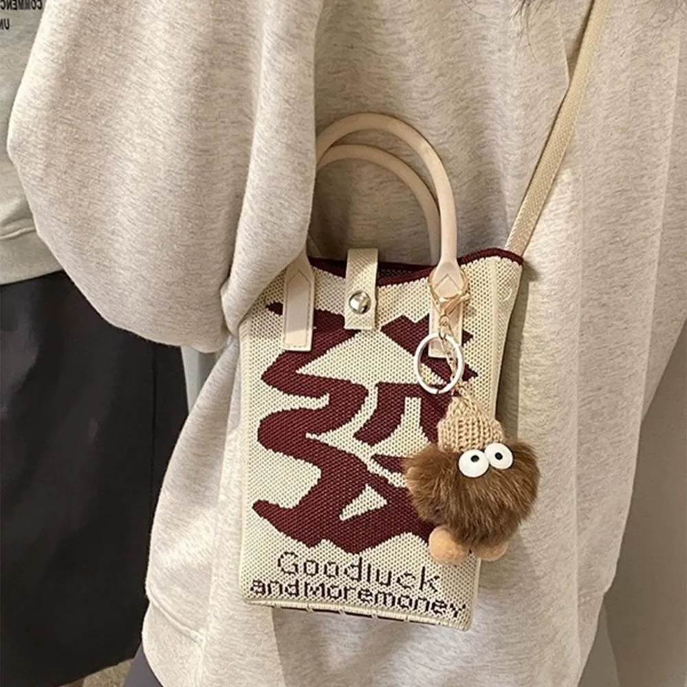 A spacious knitted small mobile wallet with a crossbody strap, suitable for women traveling with small items