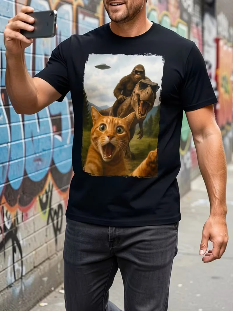 Vintage Funny Graphic T‑Shirt, Surprised Cat Selfie With Bigfoot Riding Sunglasses‑Wearing T‑Rex And UFO In Sky Print, Weird Cool Novelty Casual Unisex Short Sleeve Tee