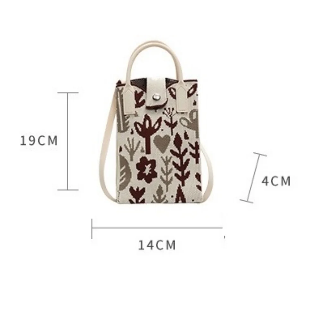 A spacious knitted small mobile wallet with a crossbody strap, suitable for women traveling with small items