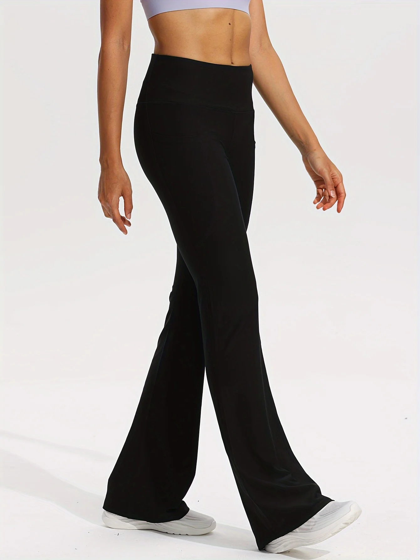 กางเกงโยคะสตรีเอวสูงสีดำ - ดีไซน์ทรงบานและมีกระเป๋า - เหมาะสำหรับเล่นกีฬาแบบสบาย ๆ ยืดได้