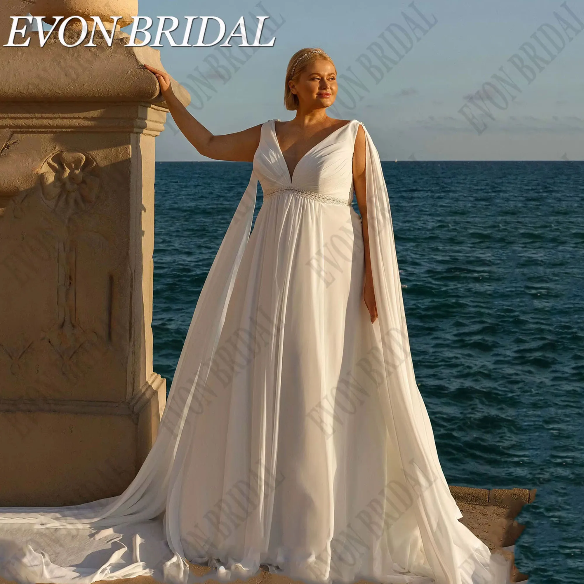 ชุดแต่งงานโอเวอร์ไซส์พร้อมผ้าคลุมไหล่ คอวี แขนกุด ชุดเจ้าสาวชายหาด ผ้าชีฟองทรงเอไลน์ ยี่ห้อ EVON BRIDAL รับตัดตามสั่ง