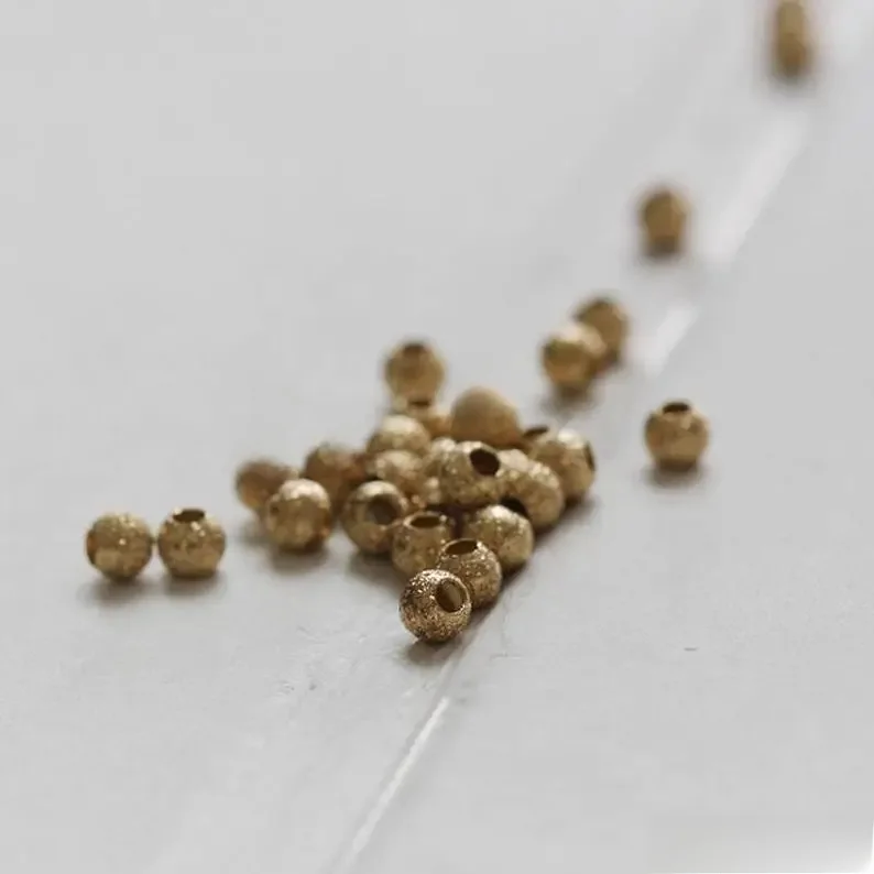 Materiały DIY - 100 sztuk okrągłych przekładek z litego mosiądzu w kolorze Stardust - 3x2,6 mm (3614C) — zdjęcie 2