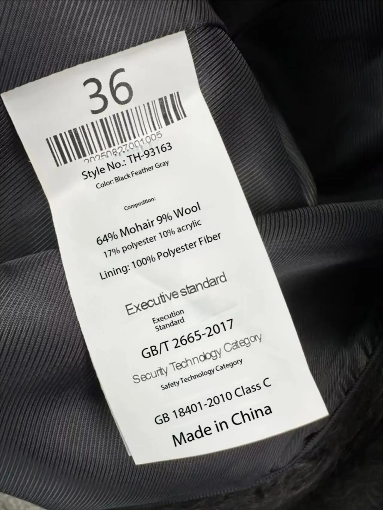 Minimalistyczny zimowy płaszcz damski ze stójką, o średniej długości, wykonany z mieszanki moheru i wełny.